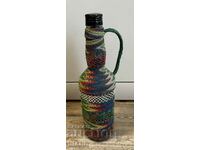 Old wicker bottle with braid, bottle glass jar