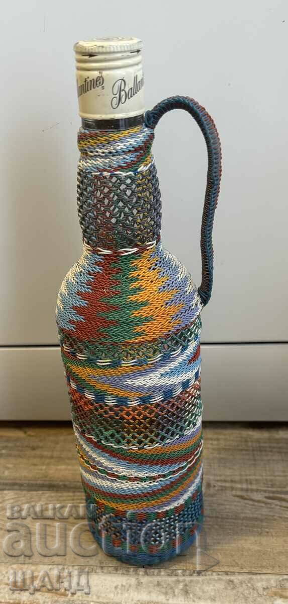 Old wicker bottle with braid, bottle glass jar