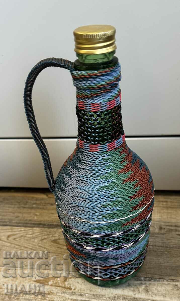 Old wicker bottle with braid, bottle glass jar