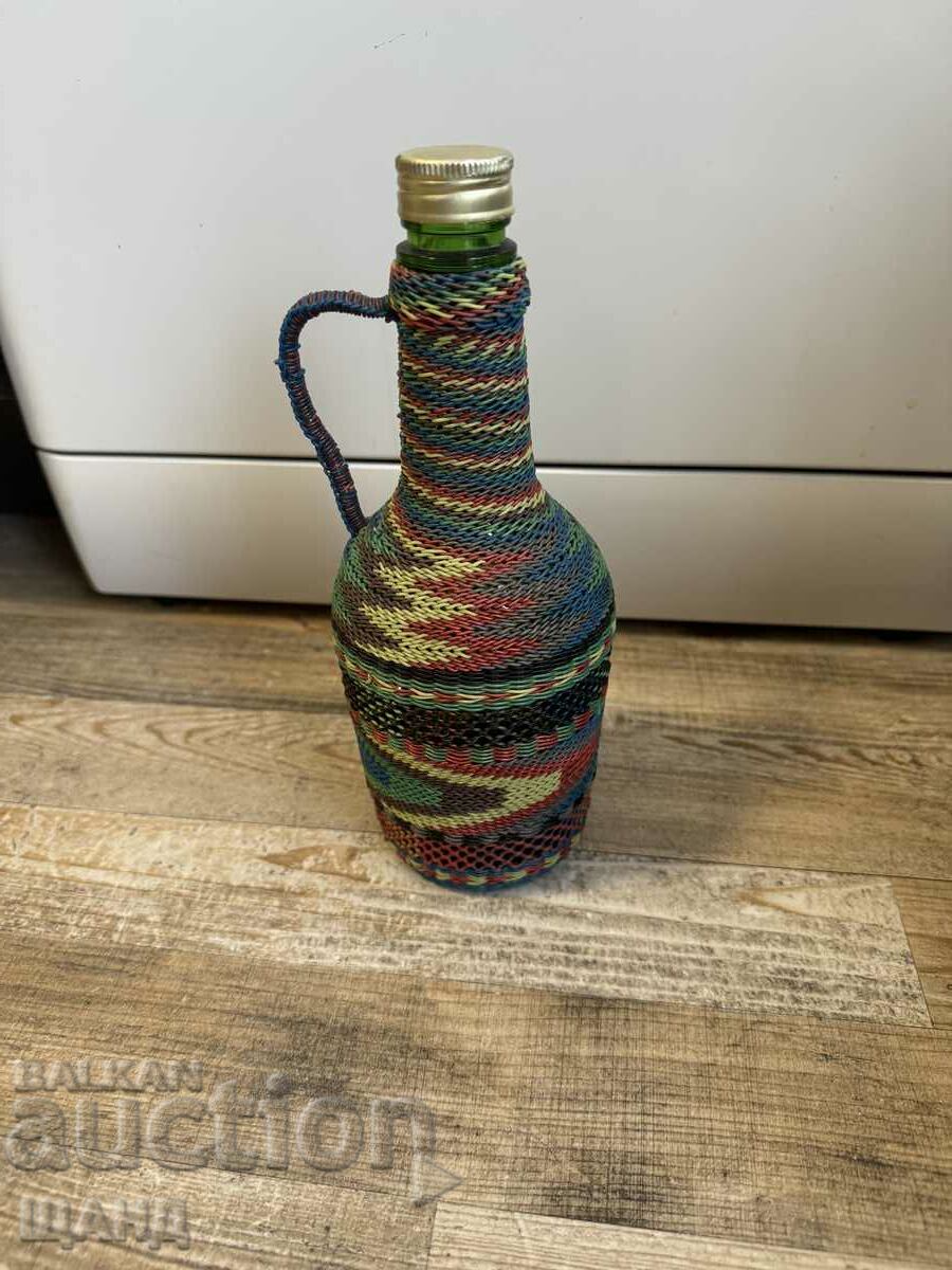 Old wicker bottle with braid, bottle glass jar