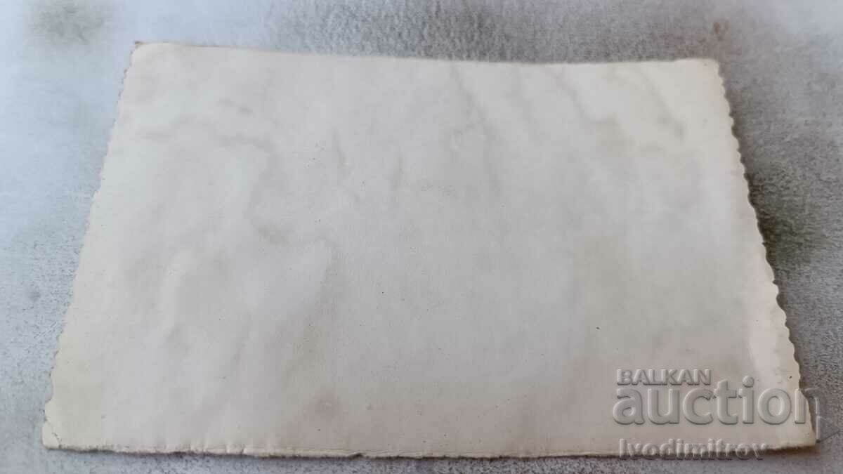 Photo Man women and young people with a black dog on the beach with price 2.35 BGN | € 1.20 Photo Man women and young people with a black dog on the beach with price 2.35 BGN | € 1.20