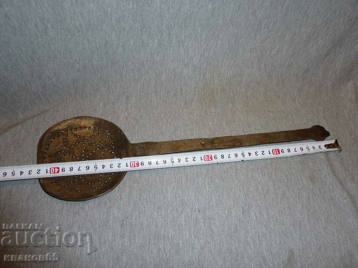 an old copper slotted spoon