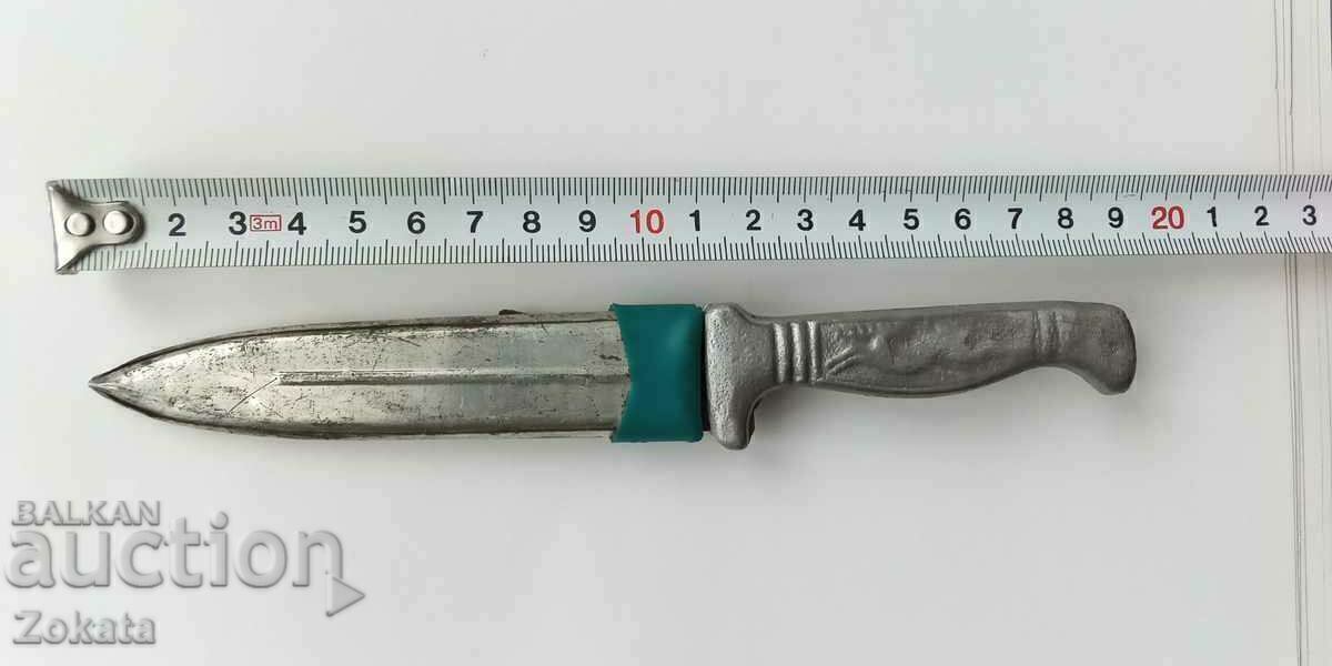 An old knife. Pebble. An old knife. Pebble.