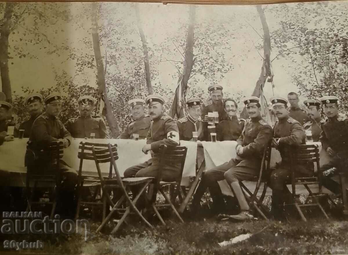Auction  Old photo paper thin senior military on table red cross