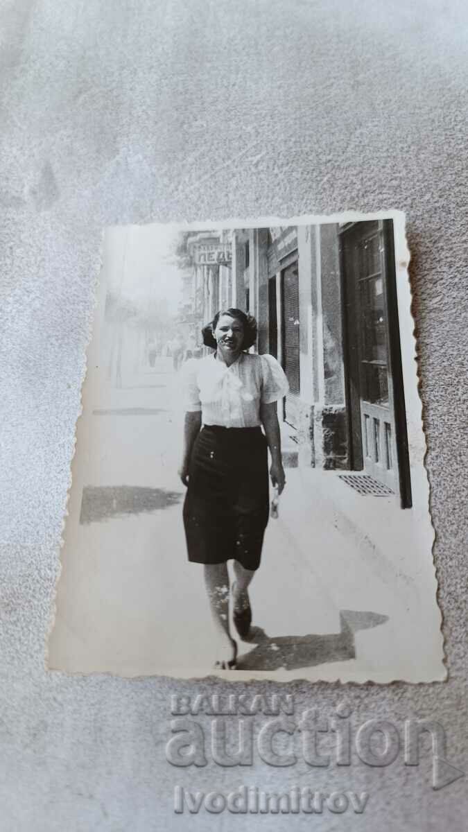 S. Sofia A woman walking in front of a shop for Factory Led