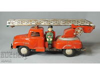 Old metal toy model fire truck with firefighters