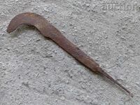 Old primitive hand-forged scythe, wrought iron