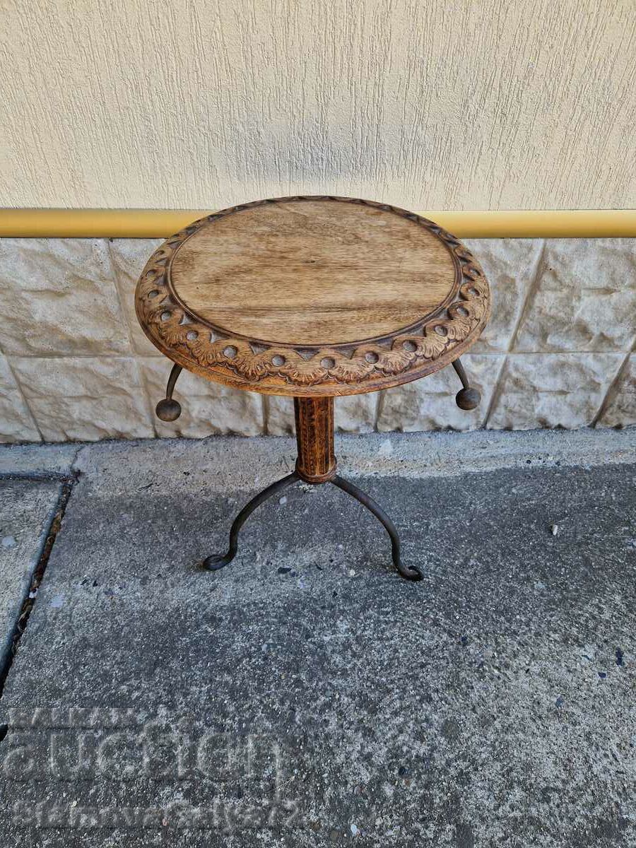 A wonderful wooden table with wrought iron