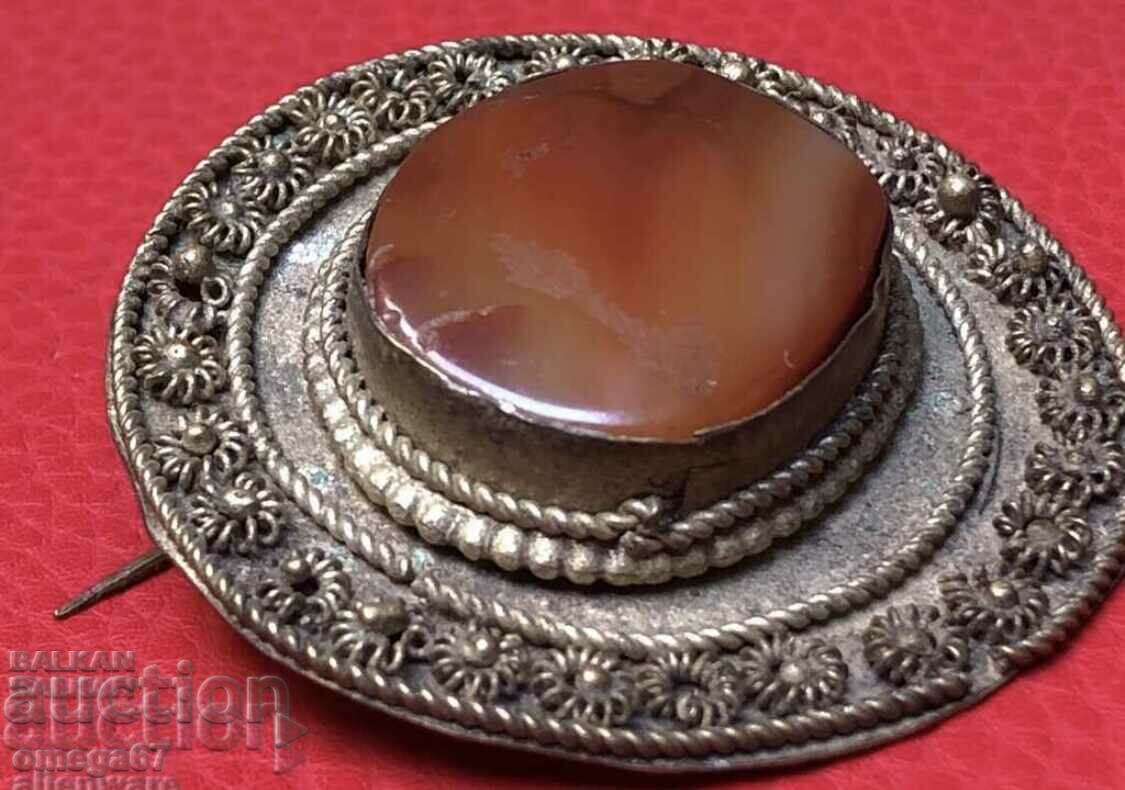 Silver brooch with carnelian