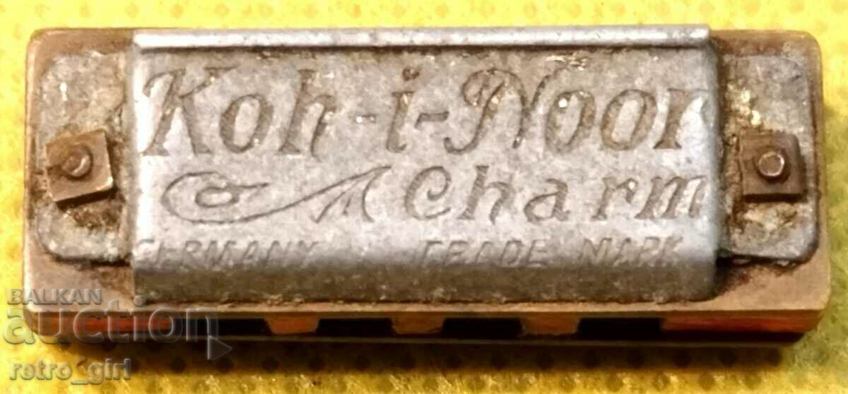 A very small branded harmonica.