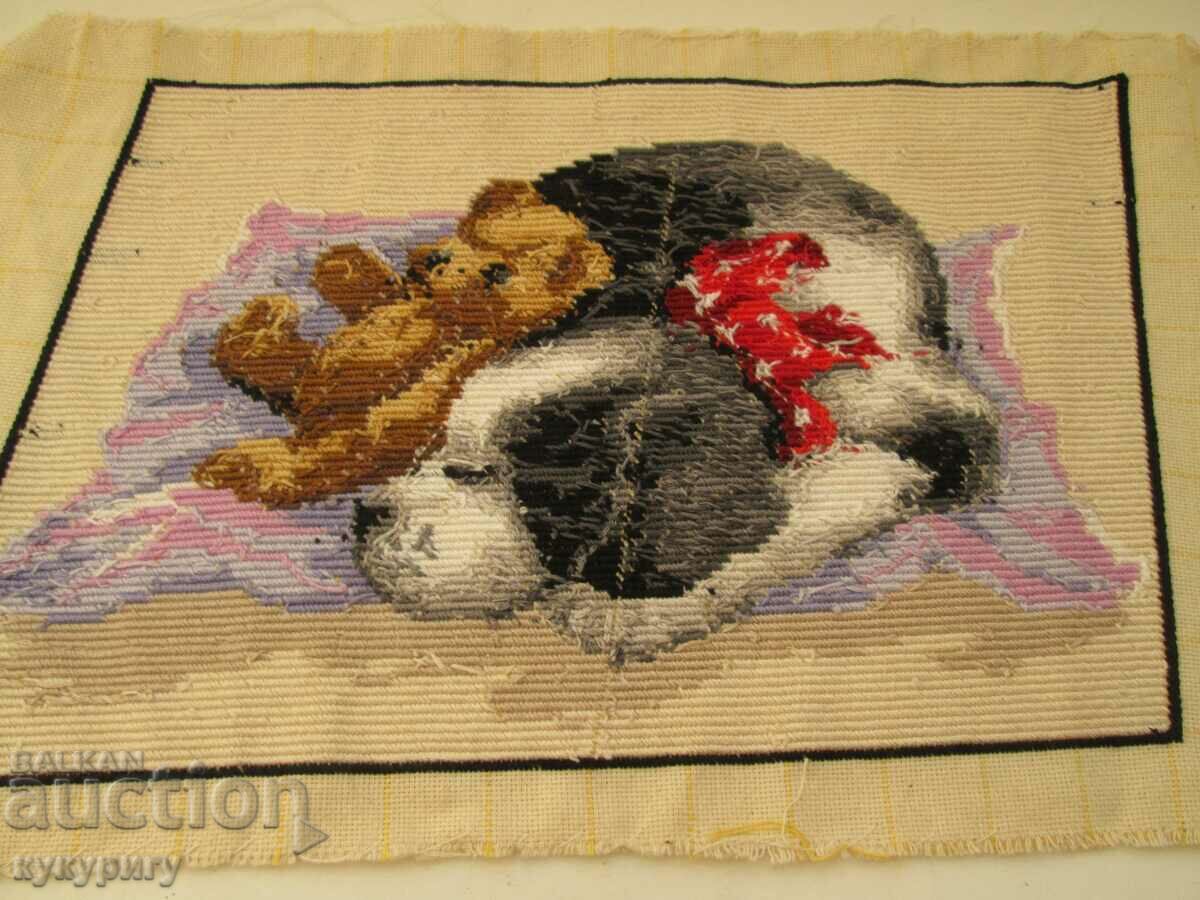 Delivery of Cute old stitched tapestry sleeping dog puppy with bear