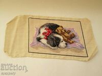 Cute old stitched tapestry sleeping dog puppy with bear