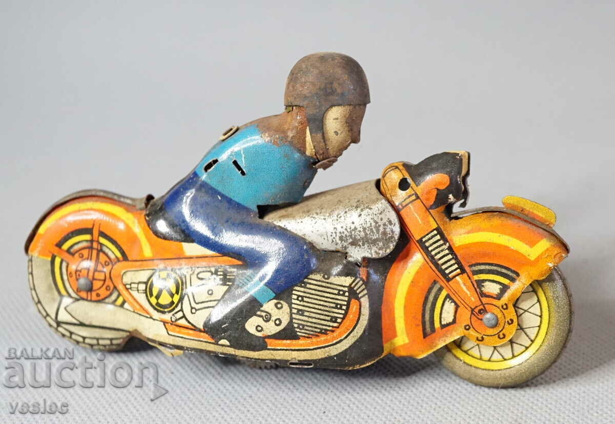 Old mechanical metal toy model bike with biker