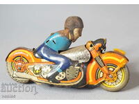 Old mechanical metal toy model bike with biker