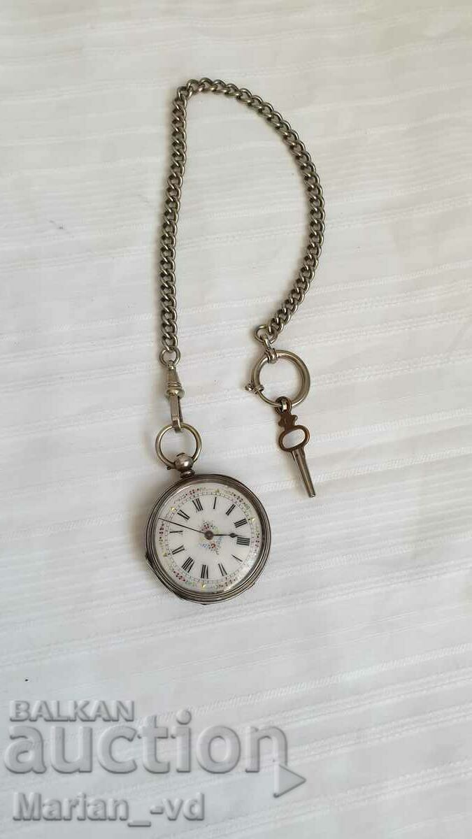 Old silver pocket watch with key and case