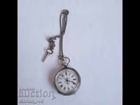 Old silver pocket watch with key and case