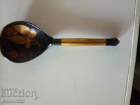 Russian wooden souvenir spoon in folk style.