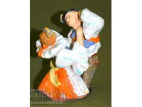 A beautiful porcelain figurine of a dancing couple