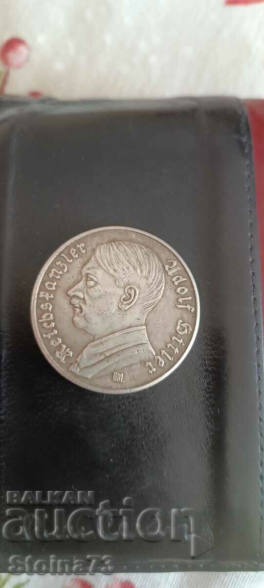 German coin with face of Adolf Hitler.