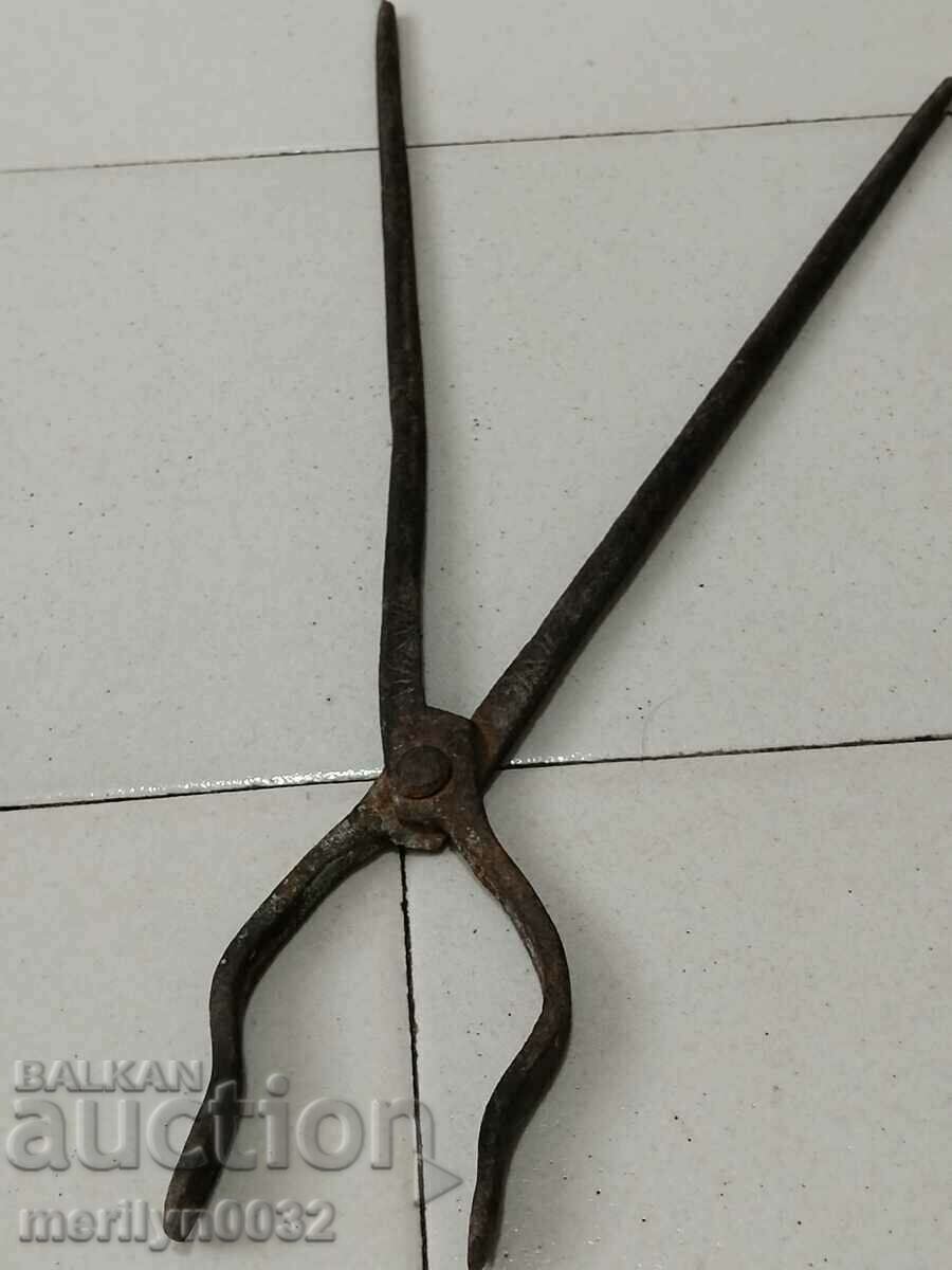 Old blacksmith's tongs, wrought iron, tile tool