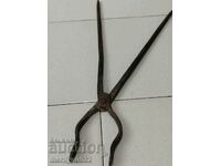 Old blacksmith's tongs, wrought iron, tile tool