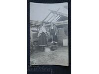 Women scoop water from a well