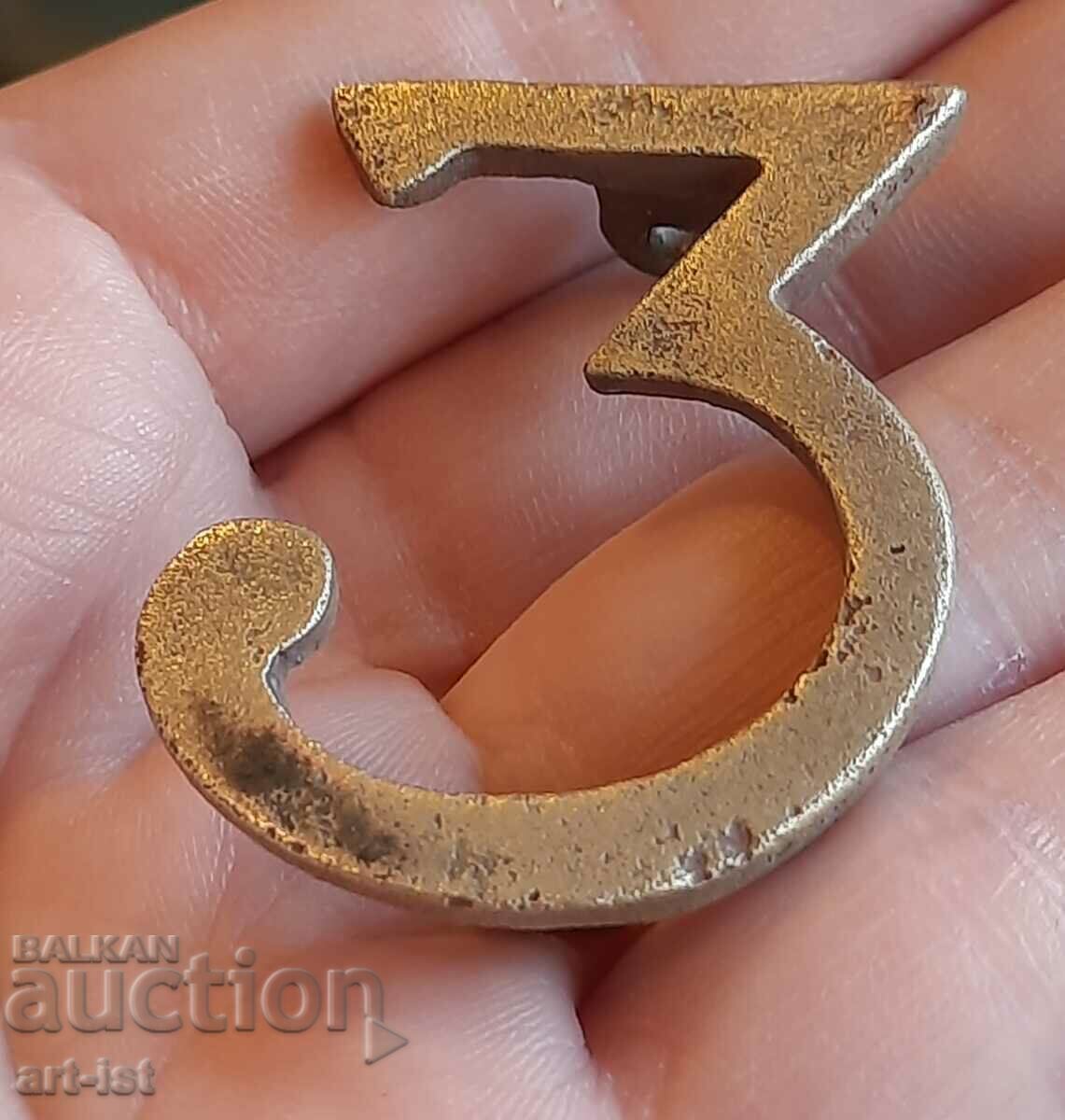 Auction  Antique bronze regimental badge.