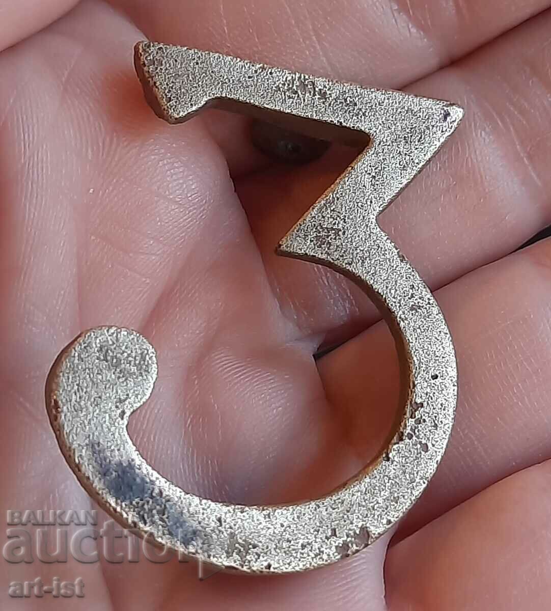 Antique bronze regimental badge.