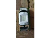 Solar floodlight with photocell