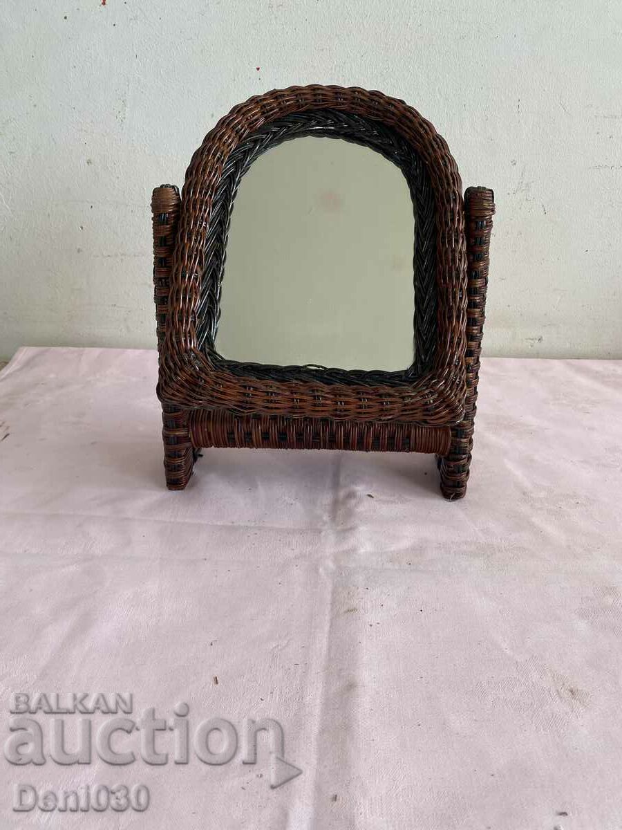 A beautiful mirror with a rattan removable stand