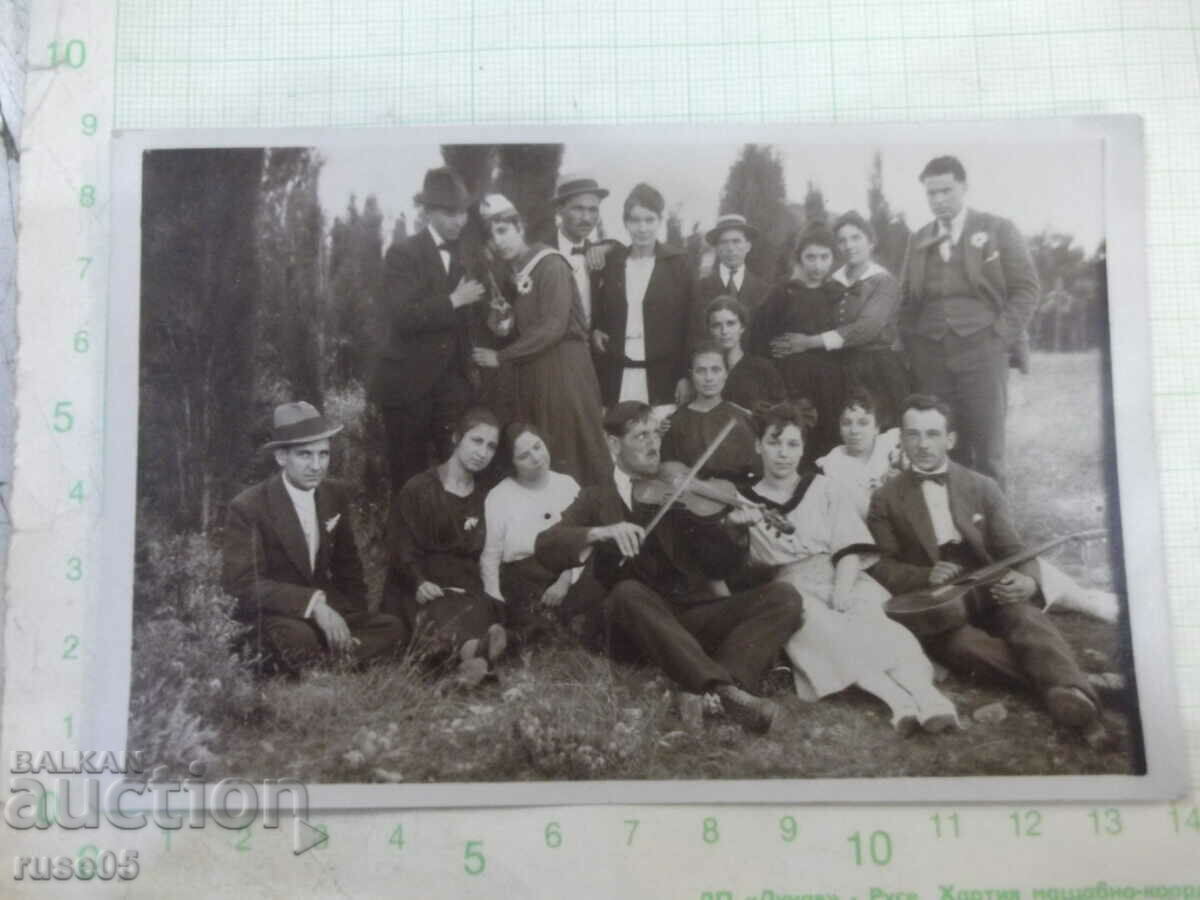 An old photo of a group of young people on an outing in nature