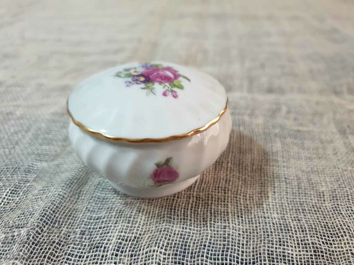 A small porcelain jewelry box