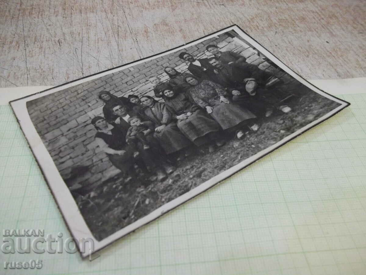 Auction Photo of an old villager on a bench in front of the wall Auction Photo of an old villager on a bench in front of the wall