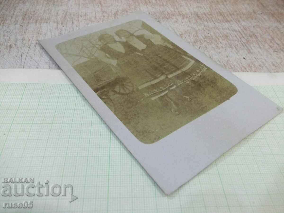 Auction Old photo of two women in costumes in front of a cart Auction Old photo of two women in costumes in front of a cart