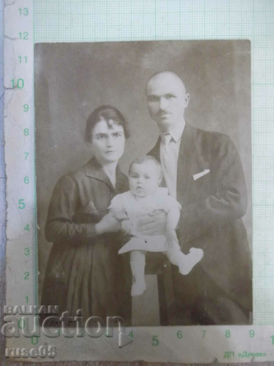 Old photo of a family with their child