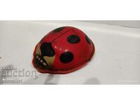 Old metal toy ladybug made of sheet metal