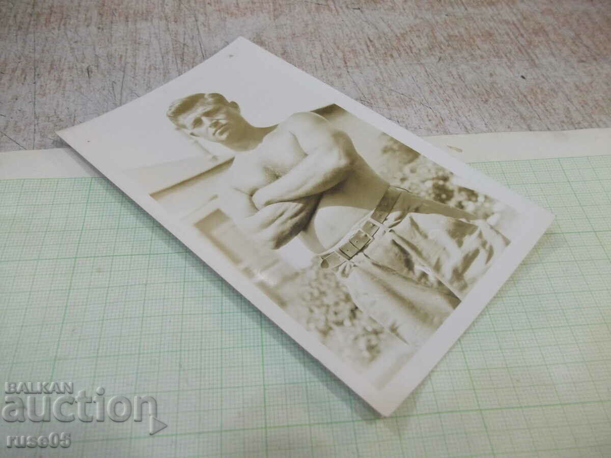 Auction Old photo of a young man with folded arms Auction Old photo of a young man with folded arms