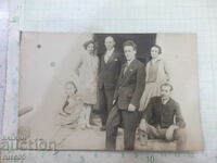 Old photo of three families in front of the door