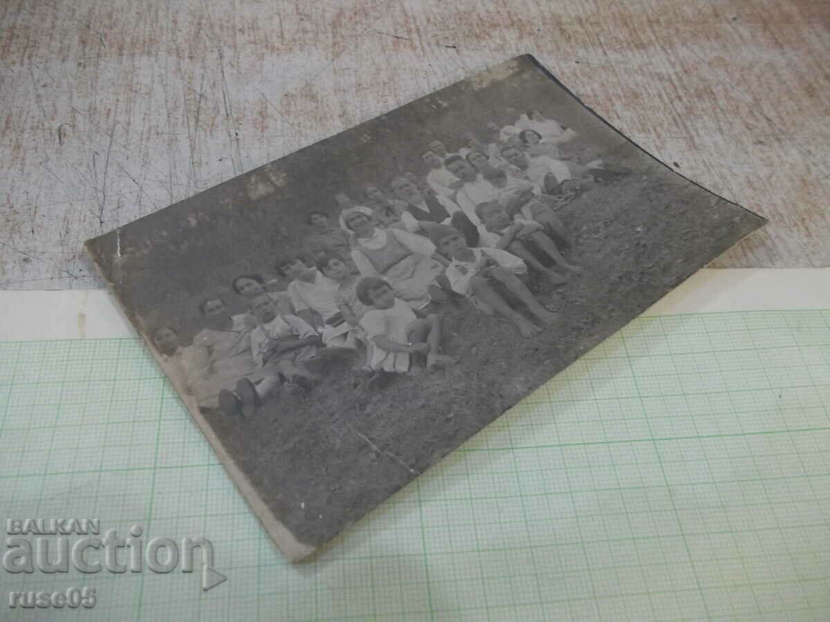 Auction Old photo of a group sitting on the grass Auction Old photo of a group sitting on the grass