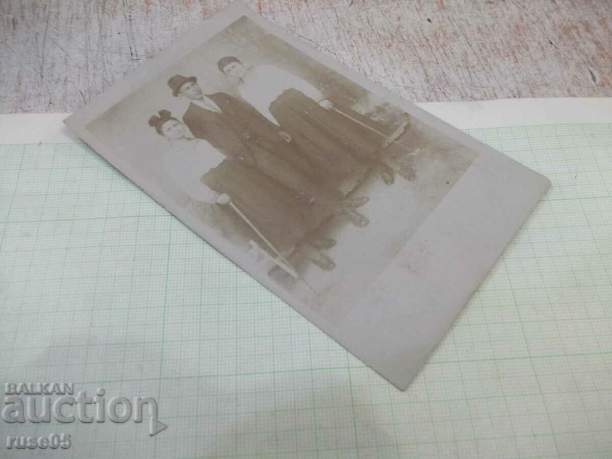 Auction Old photo of two women and a man in a photo studio Auction Old photo of two women and a man in a photo studio