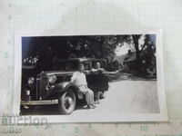 Old photo of a family in front of a house next to the car - 1