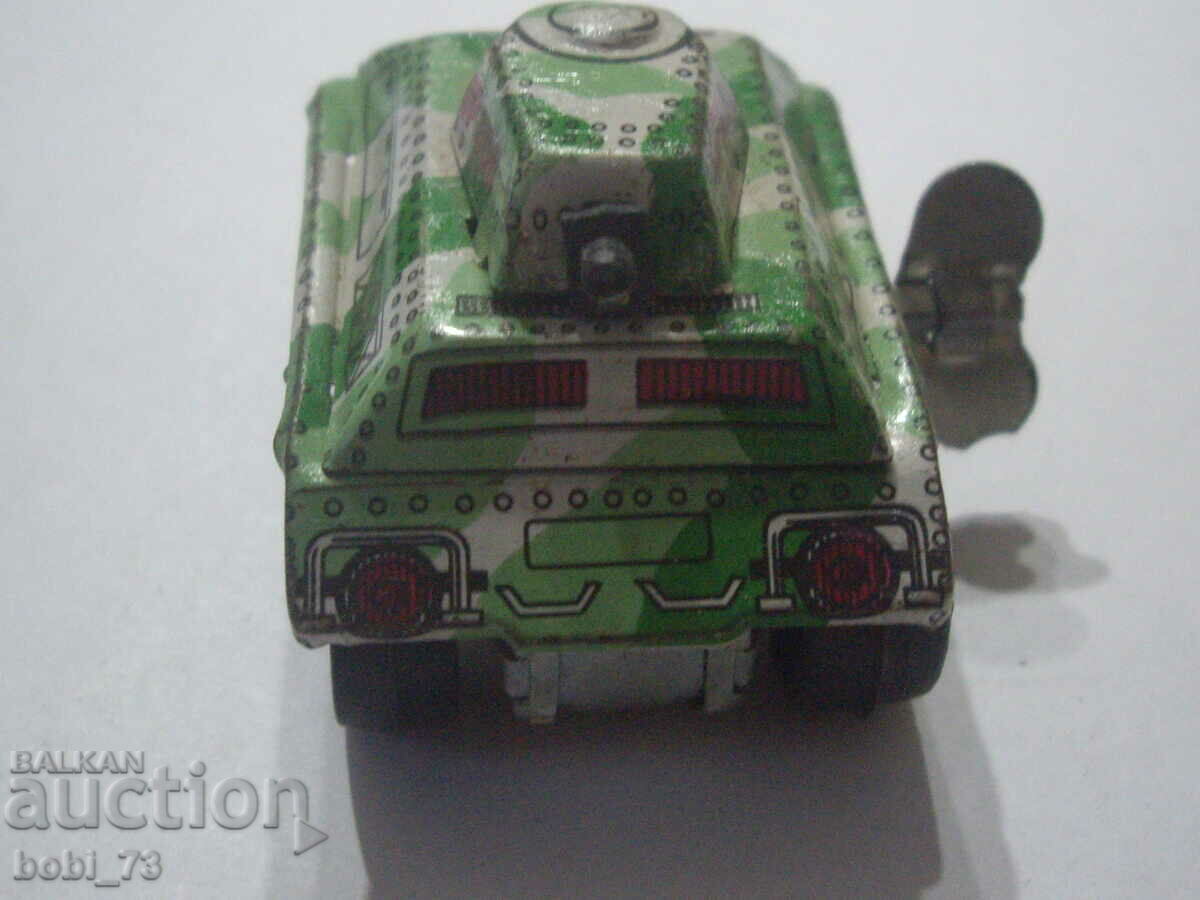 An old small tin tank with a winding key. with price 10.00 BGN | € 5.11 An old small tin tank with a winding key. with price 10.00 BGN | € 5.11