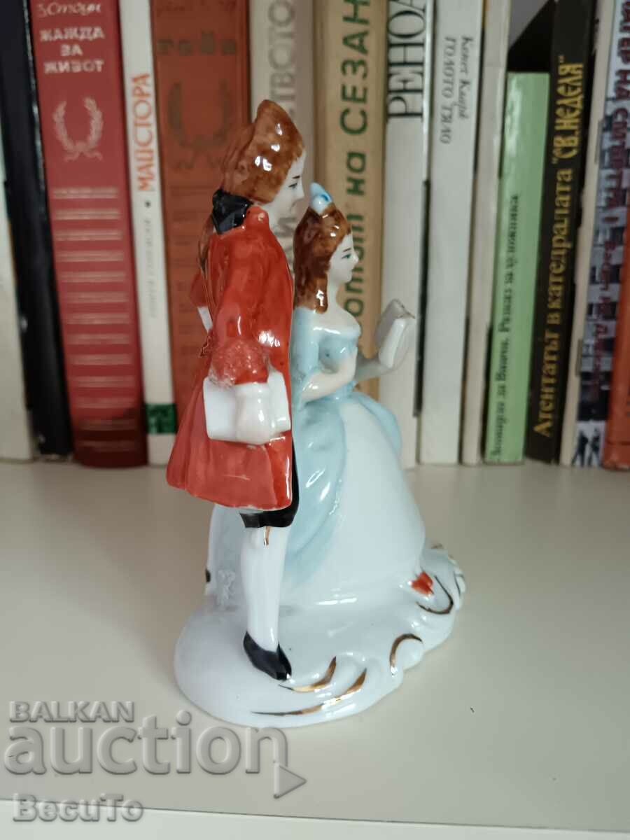 Auction Porcelain figurine of a lady with a book and a gentleman Auction Porcelain figurine of a lady with a book and a gentleman