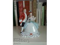 Porcelain figurine of a lady with a book and a gentleman