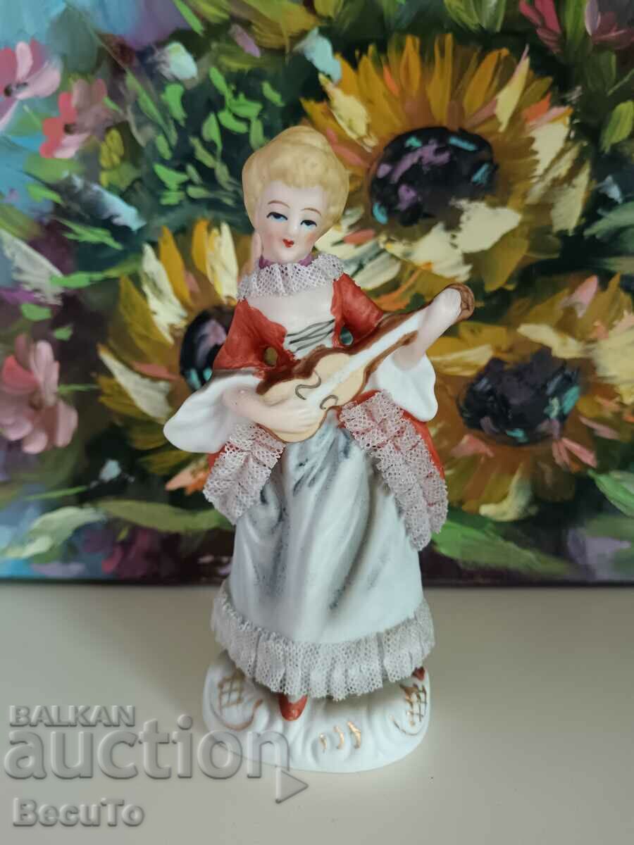 Auction Porcelain figurine of a woman with a ukulele, lace, Germany Auction Porcelain figurine of a woman with a ukulele, lace, Germany