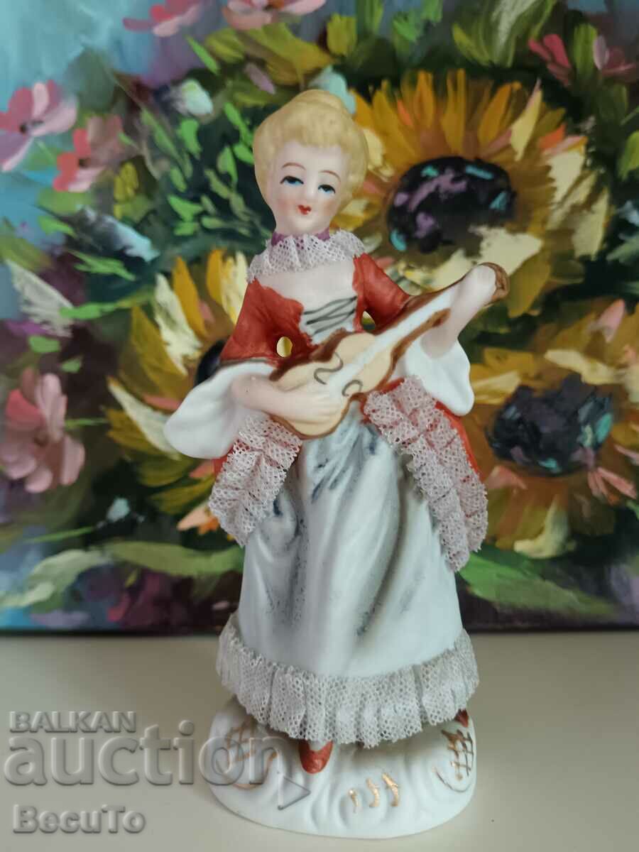 Delivery of Porcelain figurine of a woman with a ukulele, lace, Germany Delivery of Porcelain figurine of a woman with a ukulele, lace, Germany