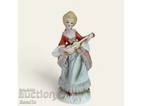 Porcelain figurine of a woman with a ukulele, lace, Germany