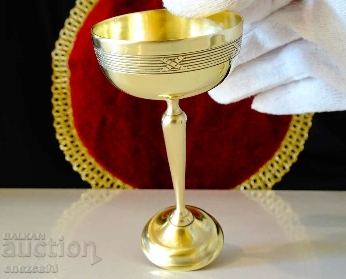 Delivery of Tall bronze glass for brandy, relief. Delivery of Tall bronze glass for brandy, relief.