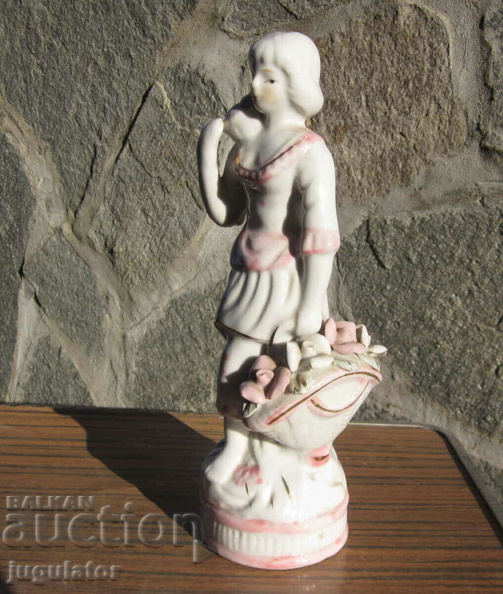 Delivery of Old porcelain figure statuette woman with a basket of roses Delivery of Old porcelain figure statuette woman with a basket of roses