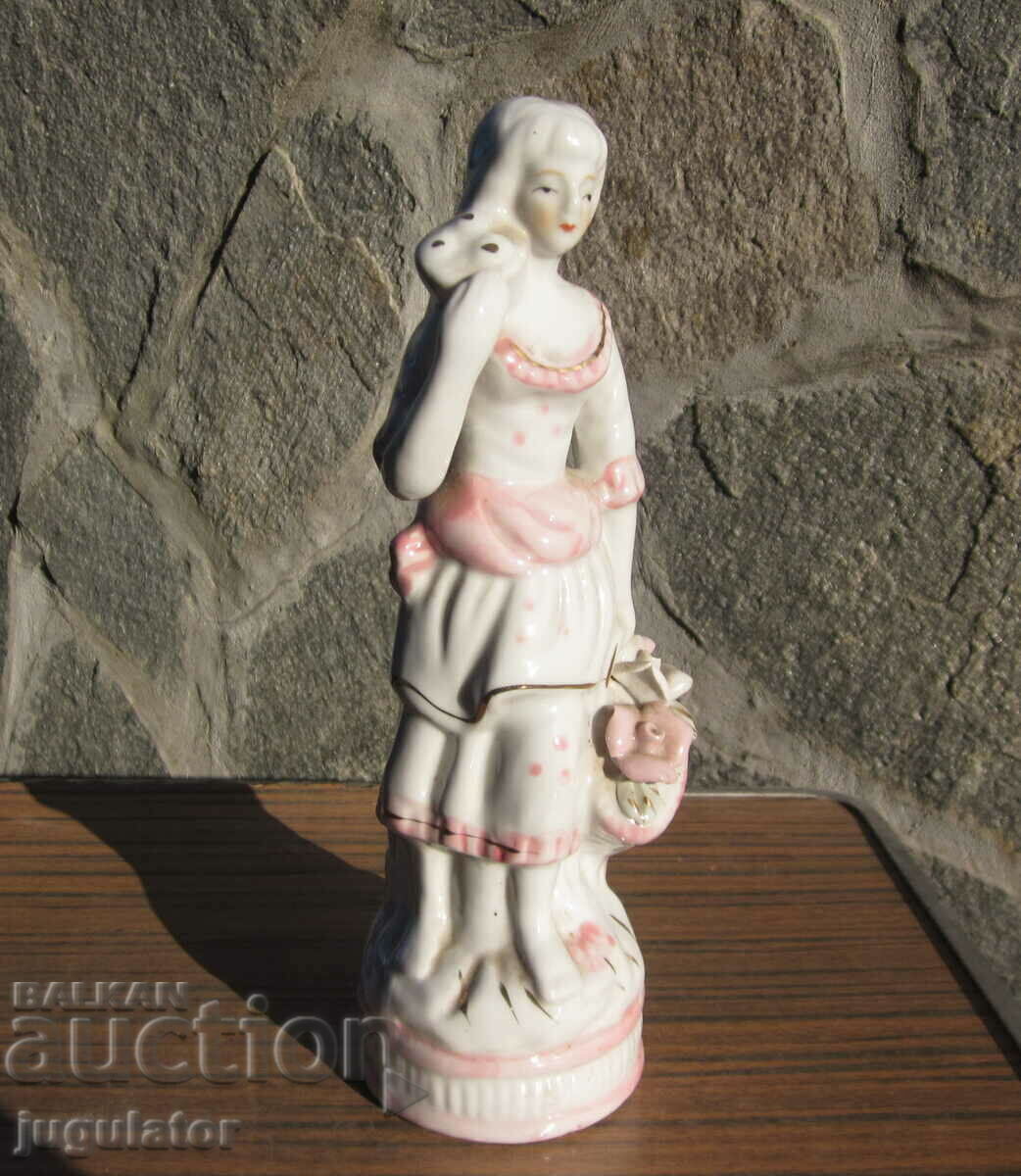 Old porcelain figure statuette woman with a basket of roses Old porcelain figure statuette woman with a basket of roses
